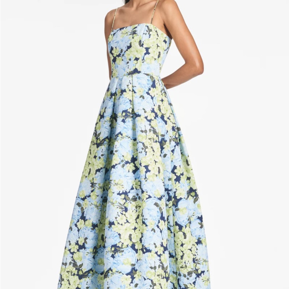 Blue and green flowered spaghetti strap gown with pockets.